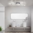 Modernes Badezimmer mit großem Spiegel, zwei Waschbecken, Wandarmaturen und LED-Deckenleuchte.